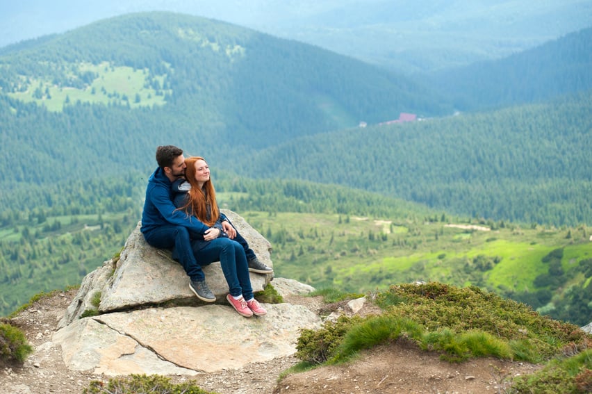 Photo of Couple Sitting on Rock